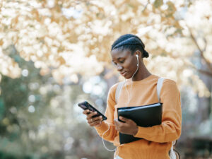 Girl on cellphone holding her books. What to Avoid When Choosing a Course