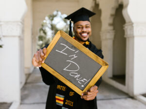 Graduate holding a sign. What to do After Graduating