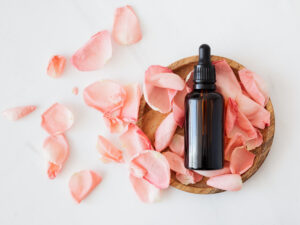 Bottle in a bed of flower petals. How to Start a Career in Beauty Therapy