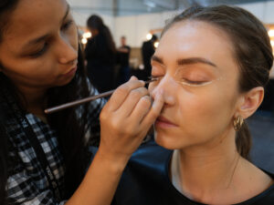 Girl doing another girls make up. How to Start a Business as a Freelance Makeup Artist
