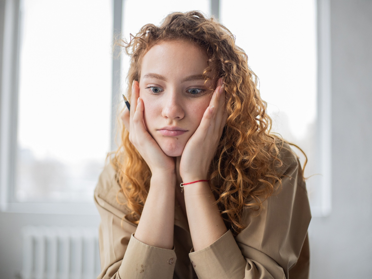 Student frowning with her head in her hands. What are your options if you failed the ICB exam? Find out right here.