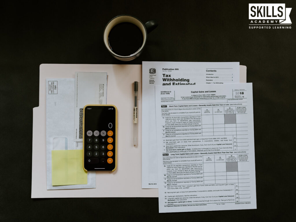 Calculator and tax forms on a table. Study bookkeeping courses in Cape Town and update your skills.
