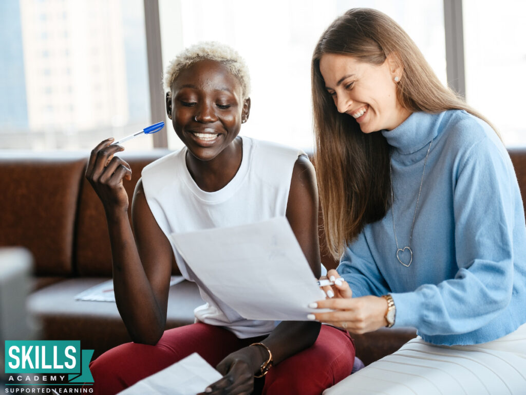 A course expert sitting with a student to discuss her college application. Take a look at our office administration entry requirements and reach your study goals with us.
